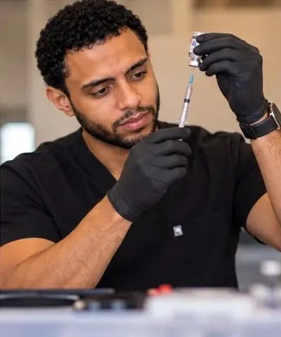 Carlos preparing an injection